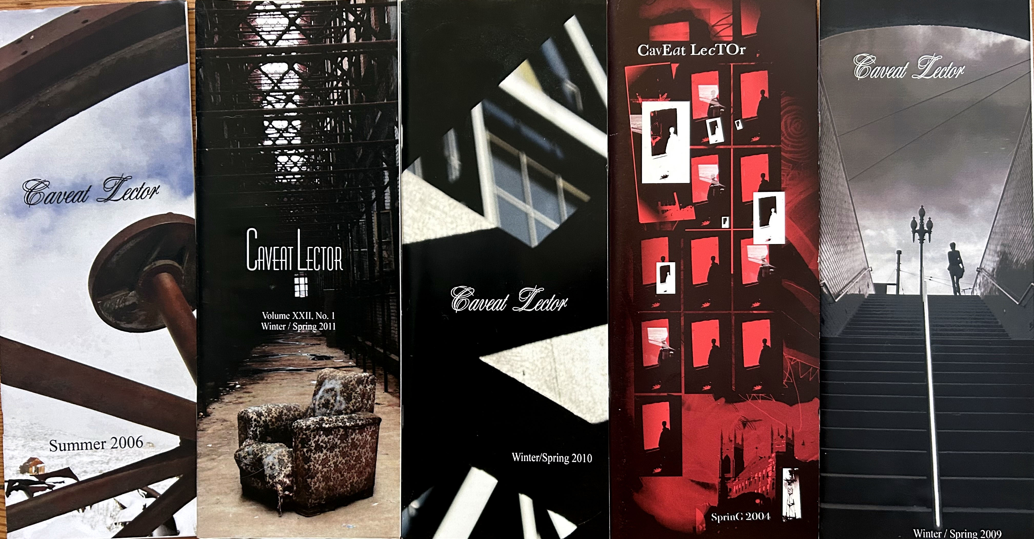 Five issues of Caveat Lector magazine standing upright