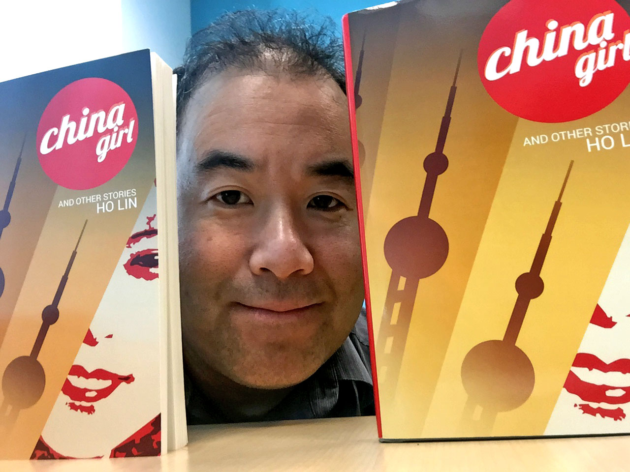 Ho Lin with copies of China Girl and Other Stories